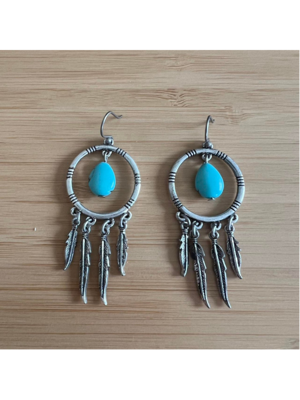 Turquoise and silver dangly earrings with turquoise beads and silver tone feathe
